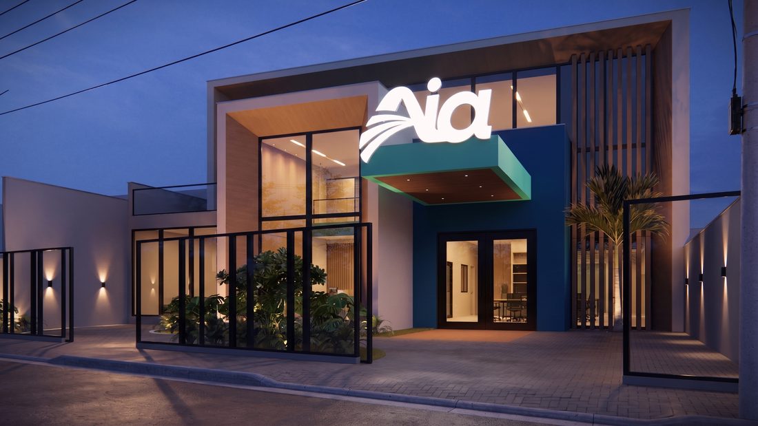 Fachada da primeira unidade Aia à noite, com o letreiro iluminado